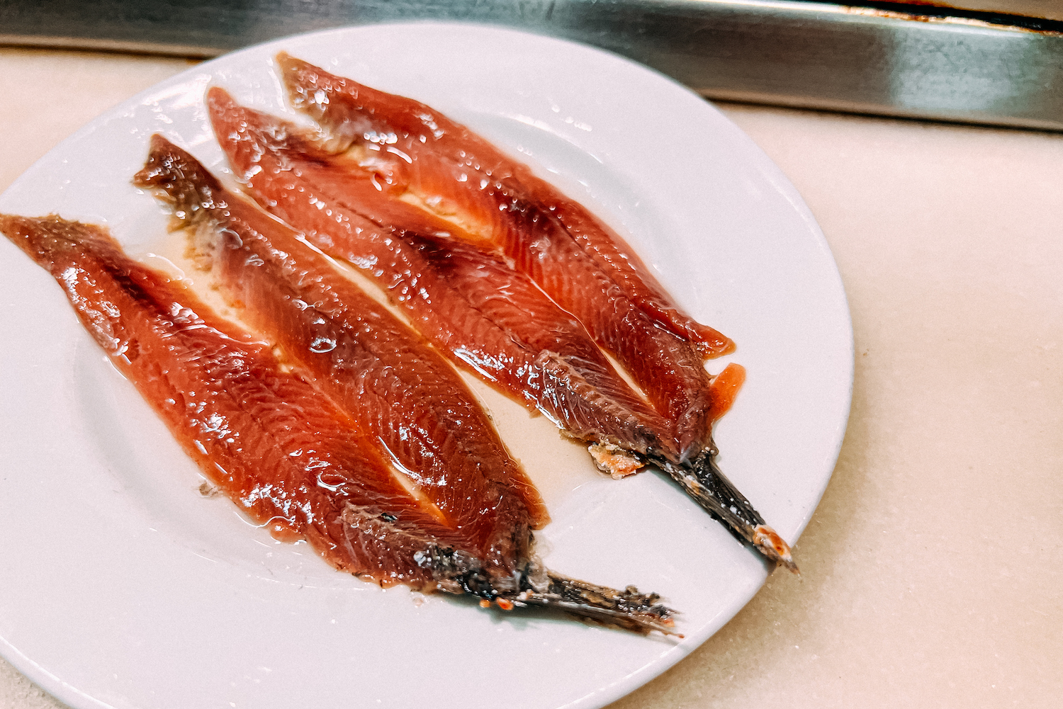 Canned Anchovies with Oil Tapa on a white plate