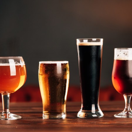 Four glasses holding different styles of beer