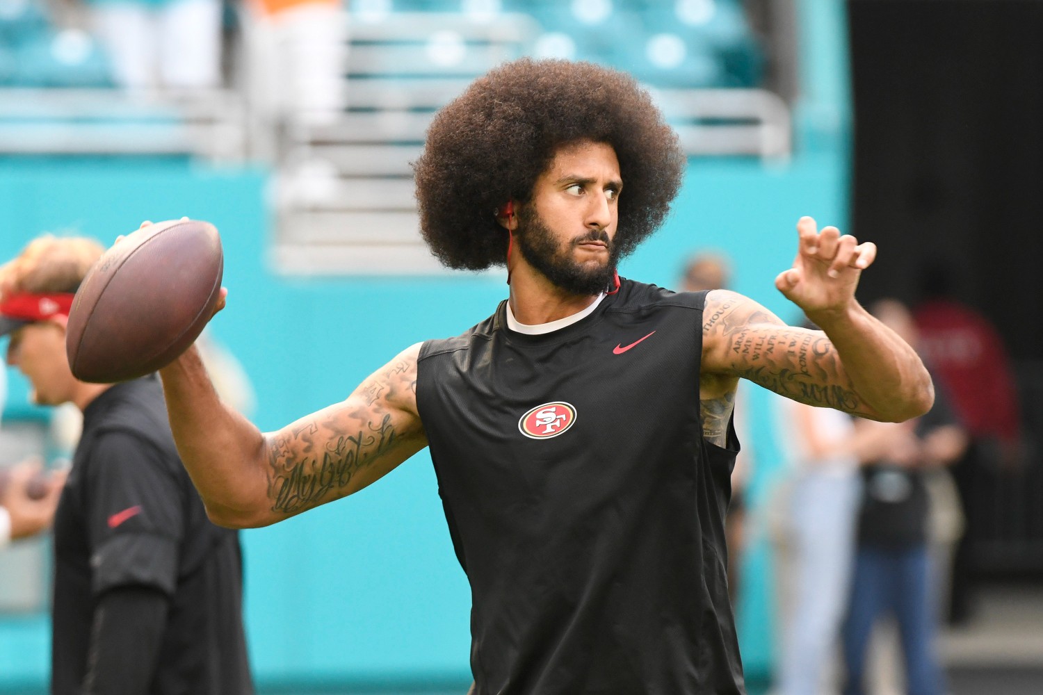 Colin Kaepernick throwing a football