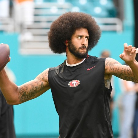 Colin Kaepernick throwing a football