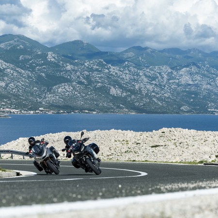 Two motorcyclists lean into a corner on the Adriatic Highway in Croatia