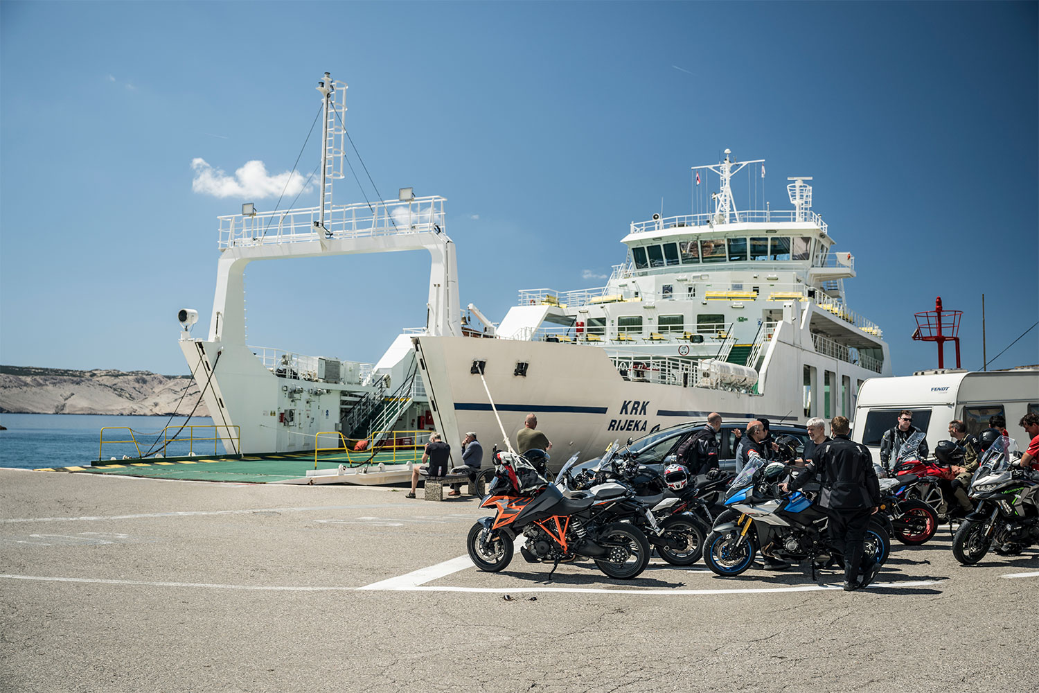 A group of motorcycle riders waiting to board a ferry in Croatia
