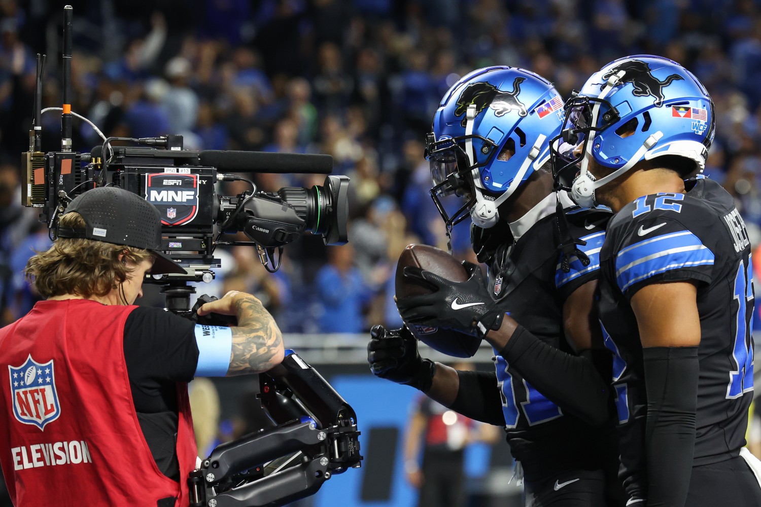 ESPN camera operator filming NFL players
