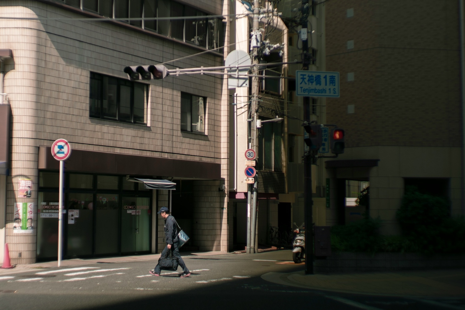 A Japanese man walking down the street.