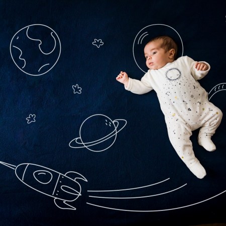 A baby in an illustration of space