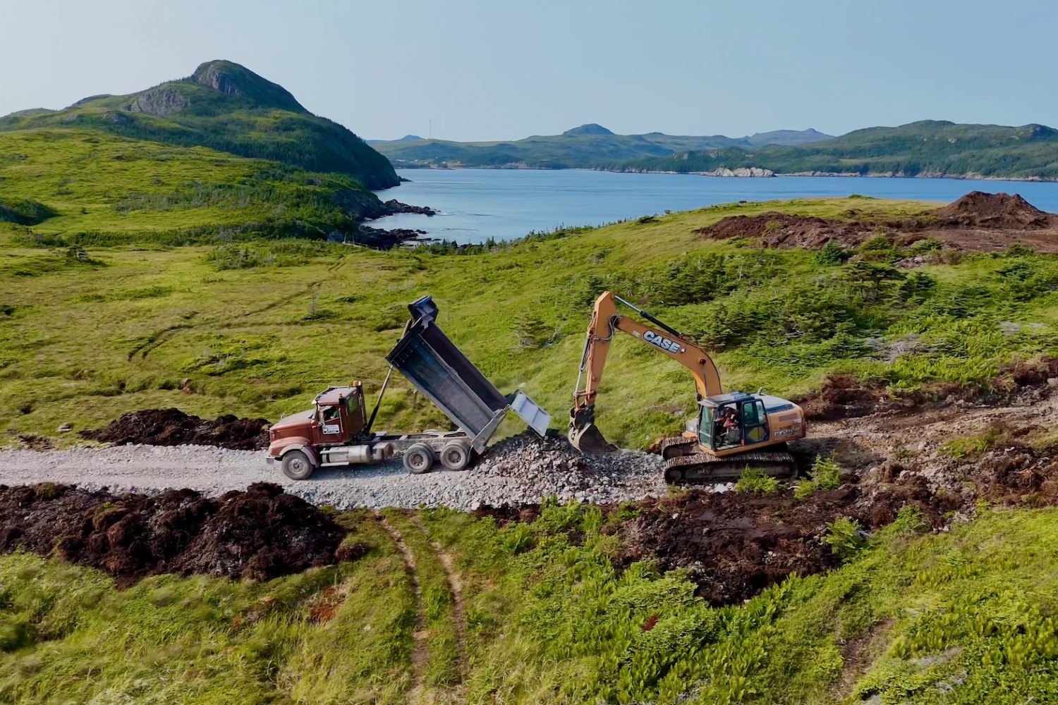 Construction equipment in a green and verdant landscape