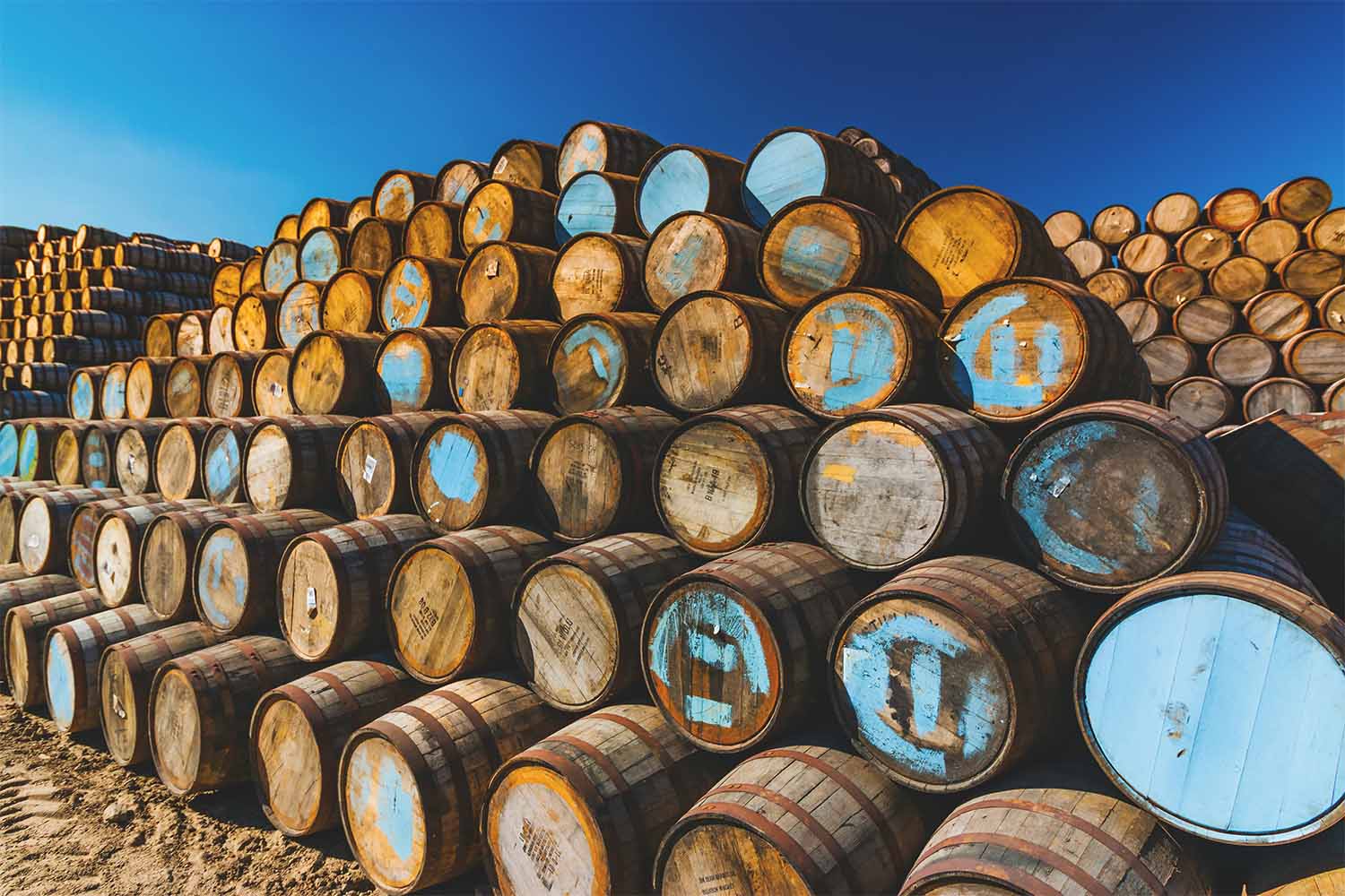 Whisky barrels stacked at a cooperage in Scotland