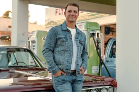 lifestyle image of Brock Purdy next to car