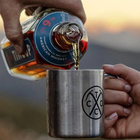 TINCUP 6 Year American Whiskey being poured into a TINCUP mug