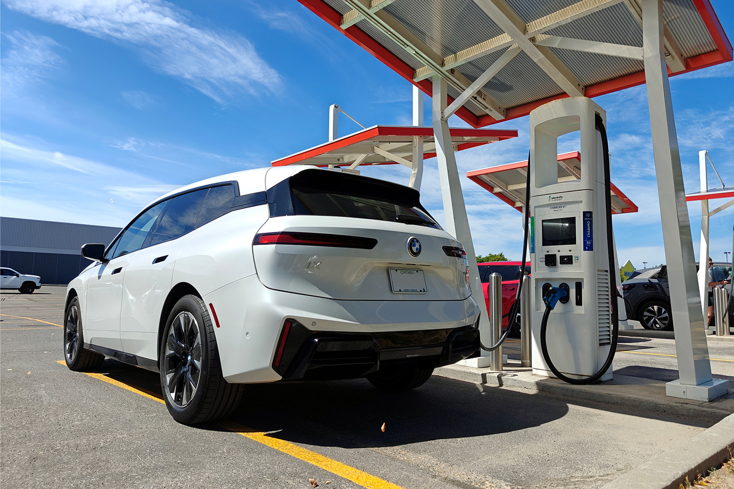 A 2026 BMW iX xDrive60 electric SUV at a charging station
