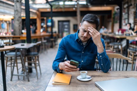 Frustrated man reading texts