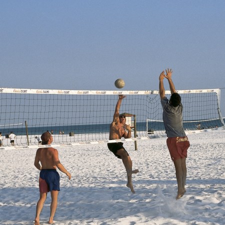 A group playing beach volleyball.