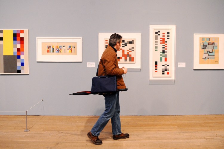 A man walking through a museum.