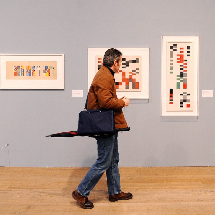 A man walking through a museum.