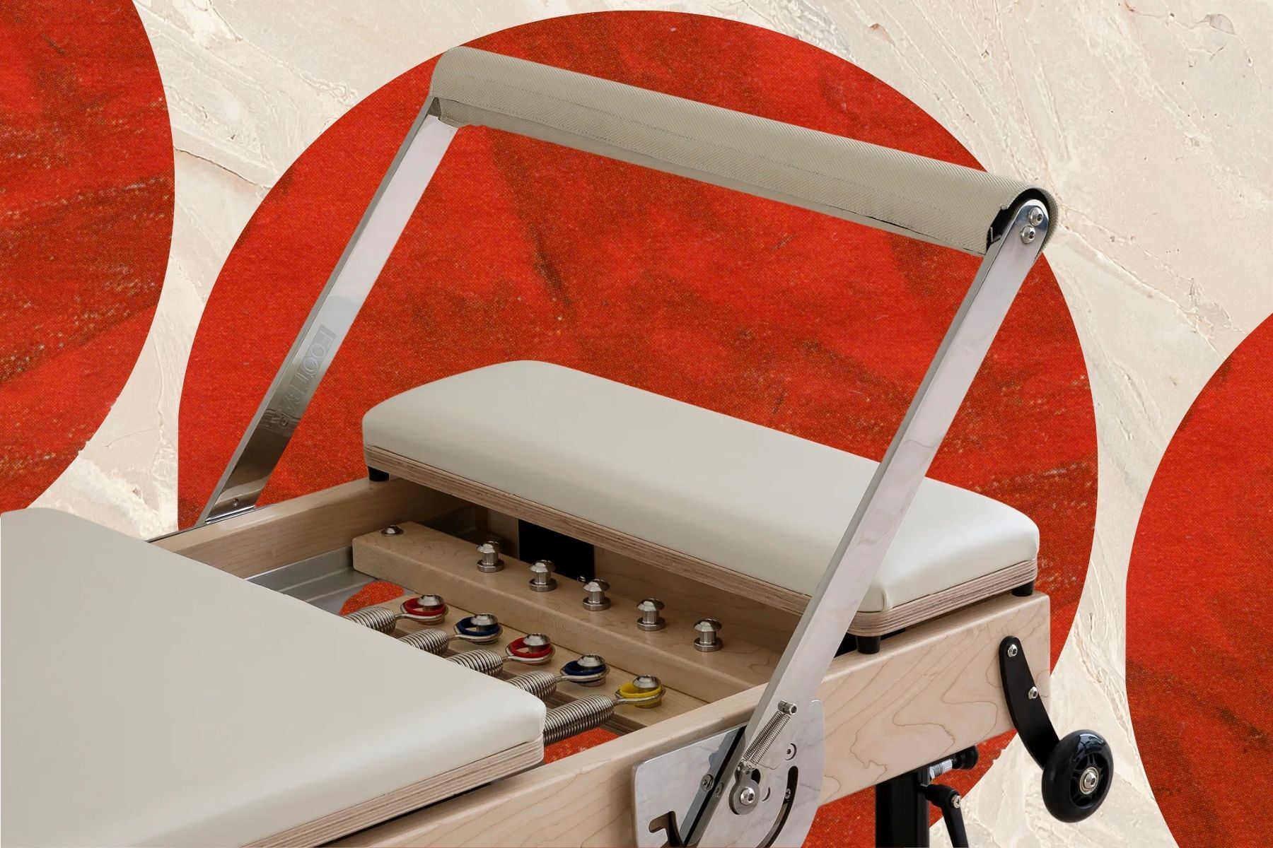 pilates reformer on textured multi-colored background