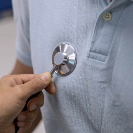 Doctor checking a patient's heartbeat