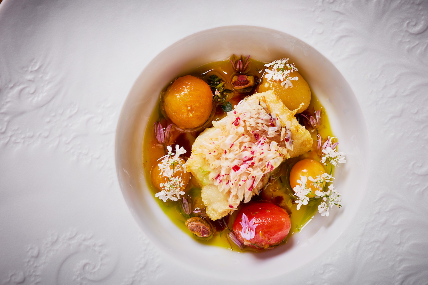 Crispy golden tile fish with sun gold tomato sauce vierge from l'abeille