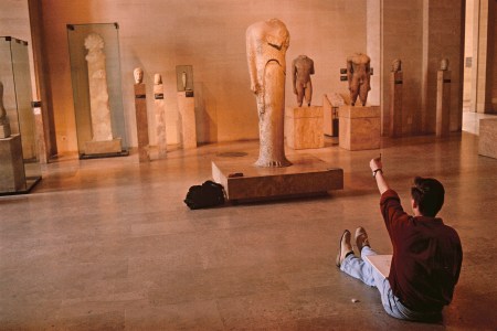 A man sitting in a museum.