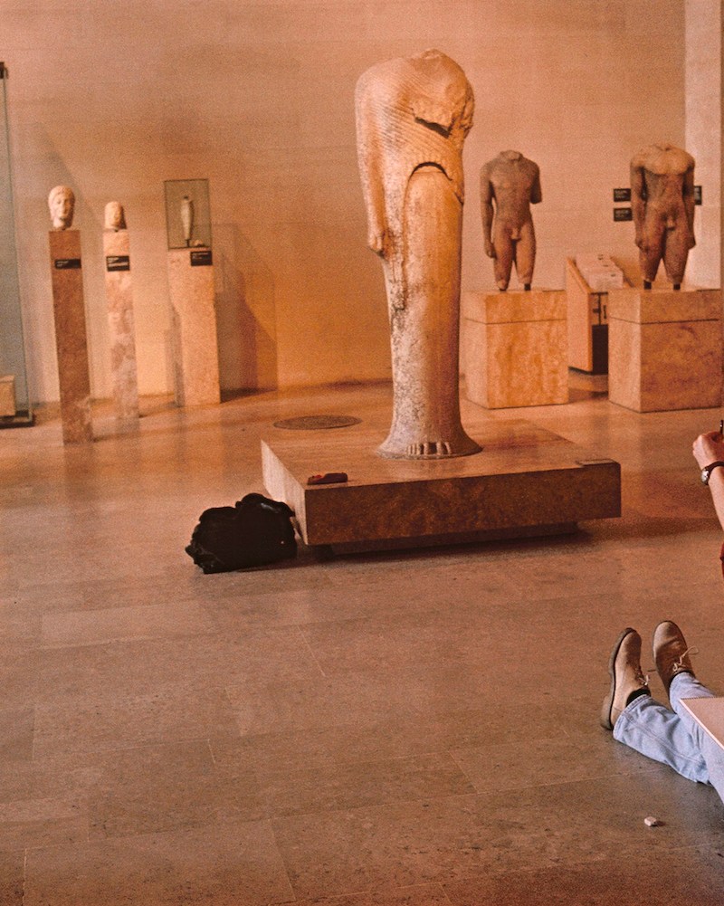 A man sitting in a museum.