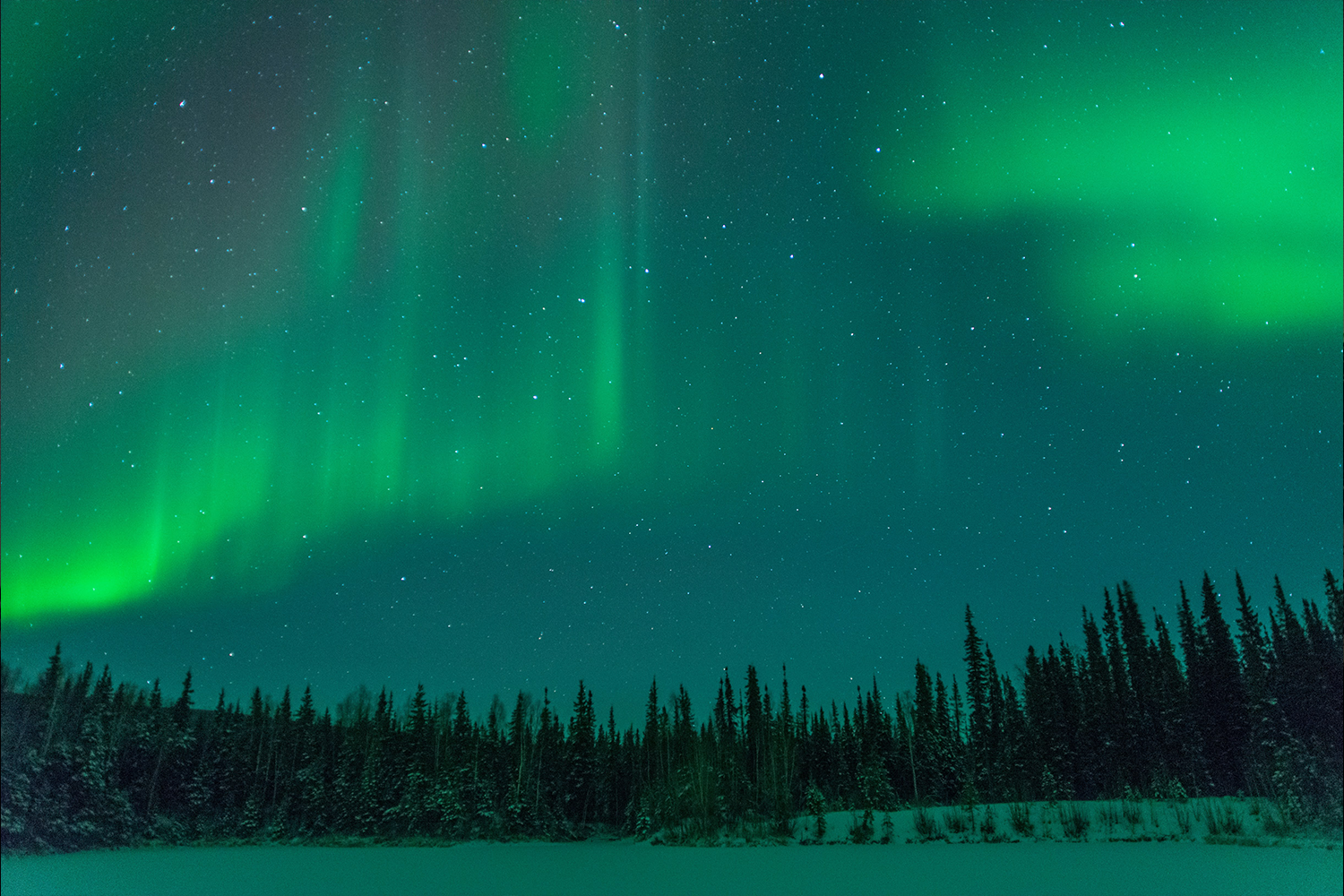 Green ribbons sweeping over Alaska