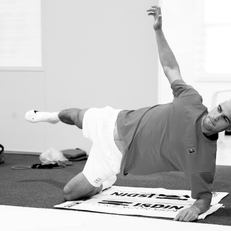 Carlos Alcaraz performing a modified plank, a move that can help with your posture alignment