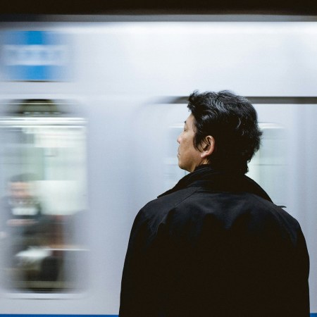 A man standing in front of a train.