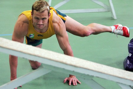 A rugby captain practicing fire hydrants for hip mobility.