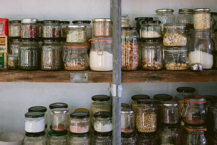 A row of jars on a shelf.
