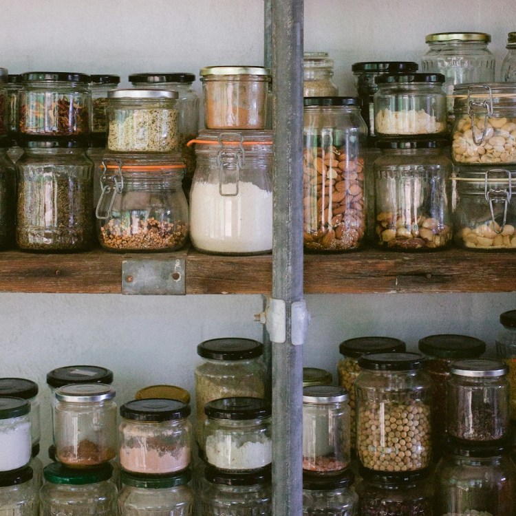 A row of jars on a shelf.