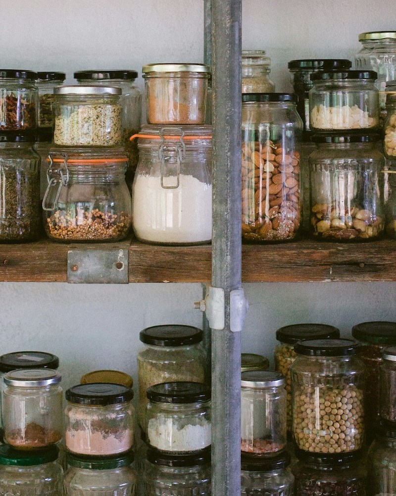 A row of jars on a shelf.