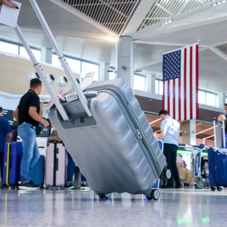 travelers with suitcases at Newark Airport