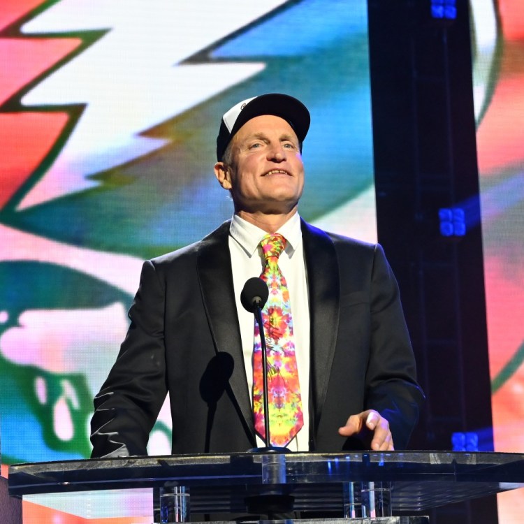 Woody Harrelson speaking at a podium