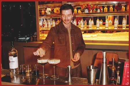 Patrick Schwarzenegger garnishing a ketel one espresso martini behind the bar