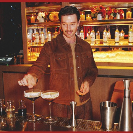 Patrick Schwarzenegger garnishing a ketel one espresso martini behind the bar