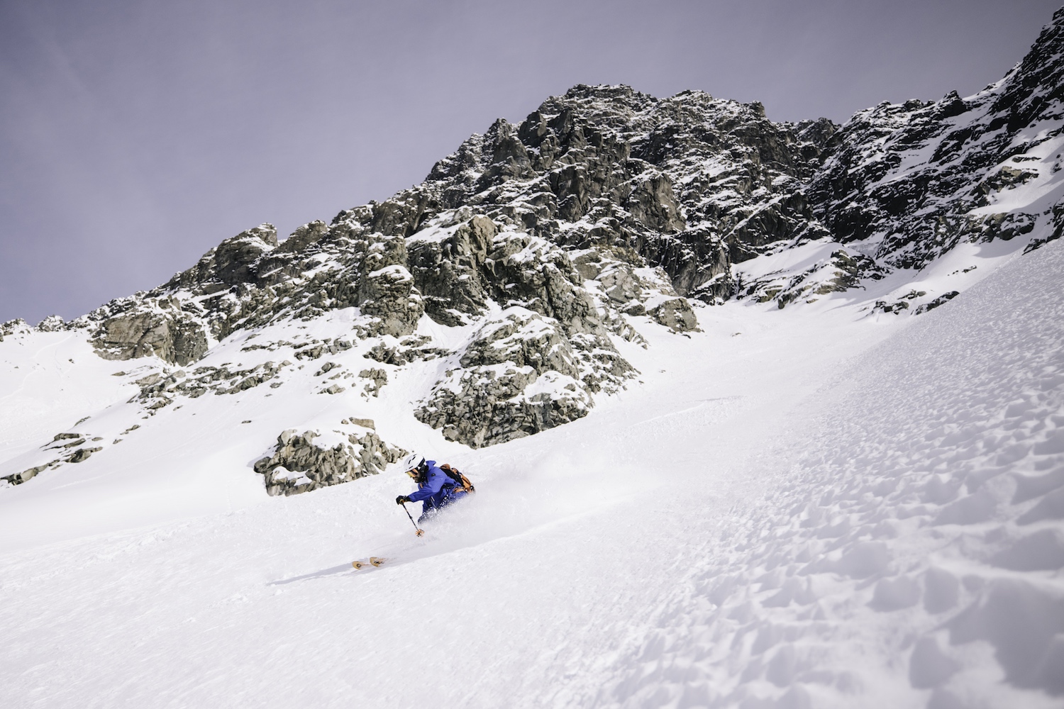 A skier carves down the mountain.