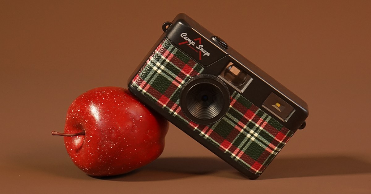 A Camp Snap camera leaning on an apple. The tech gift is one of 40 gifts we picked under $50.