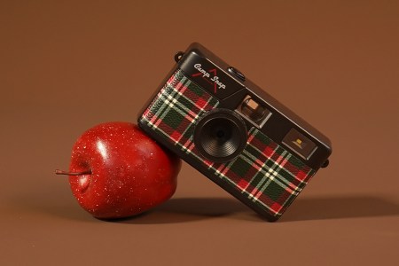A Camp Snap camera leaning on an apple. The tech gift is one of 40 gifts we picked under $50.