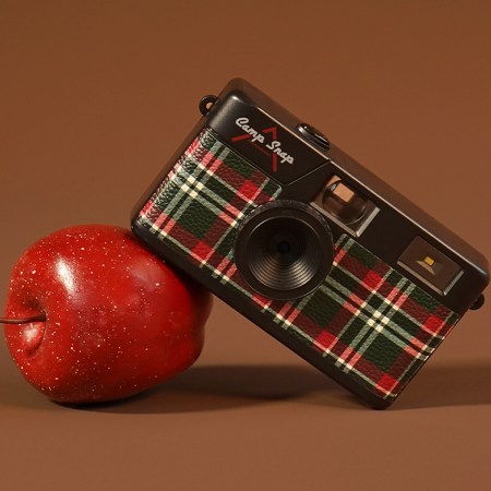 A Camp Snap camera leaning on an apple. The tech gift is one of 40 gifts we picked under $50.