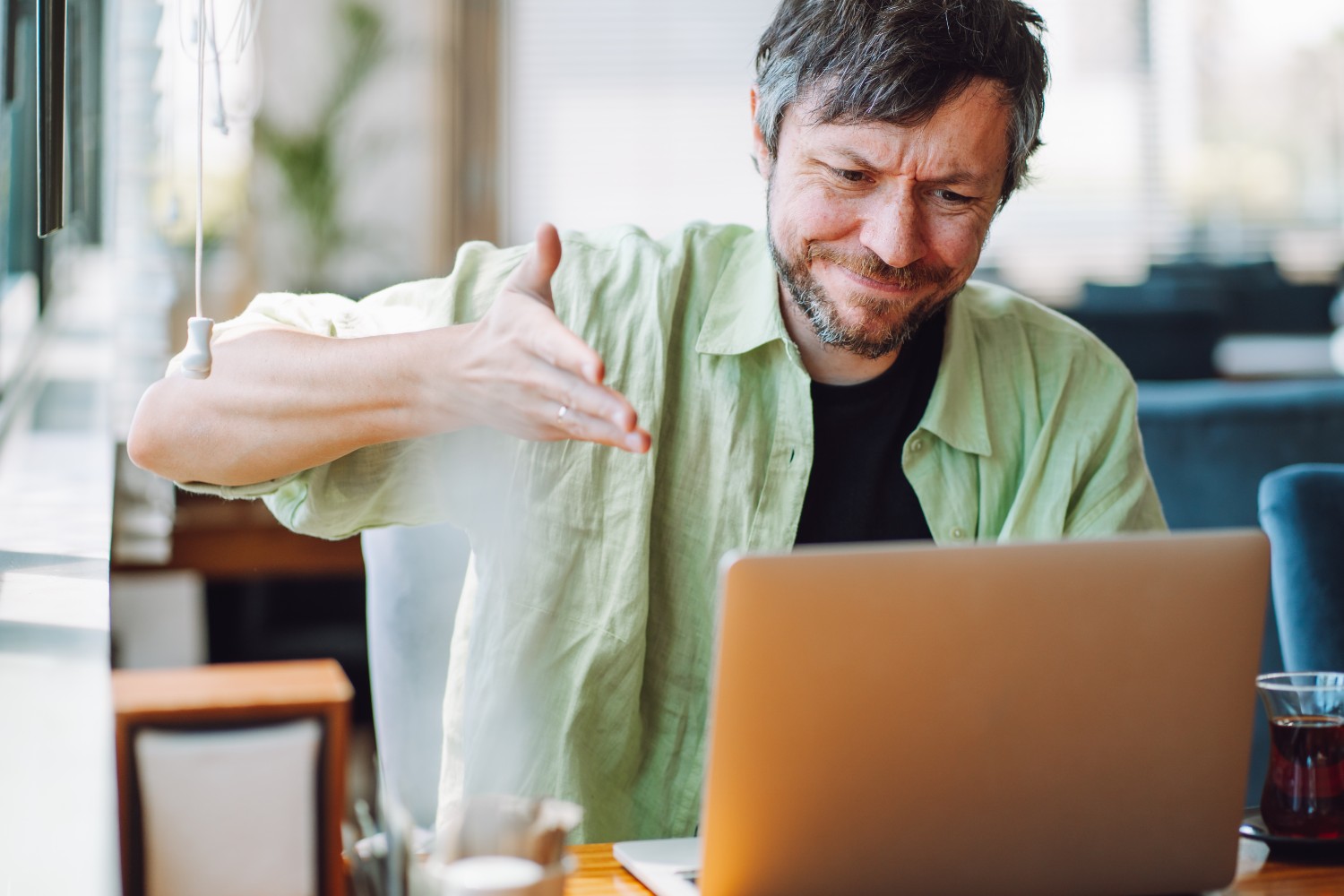 Angry man looking at laptop
