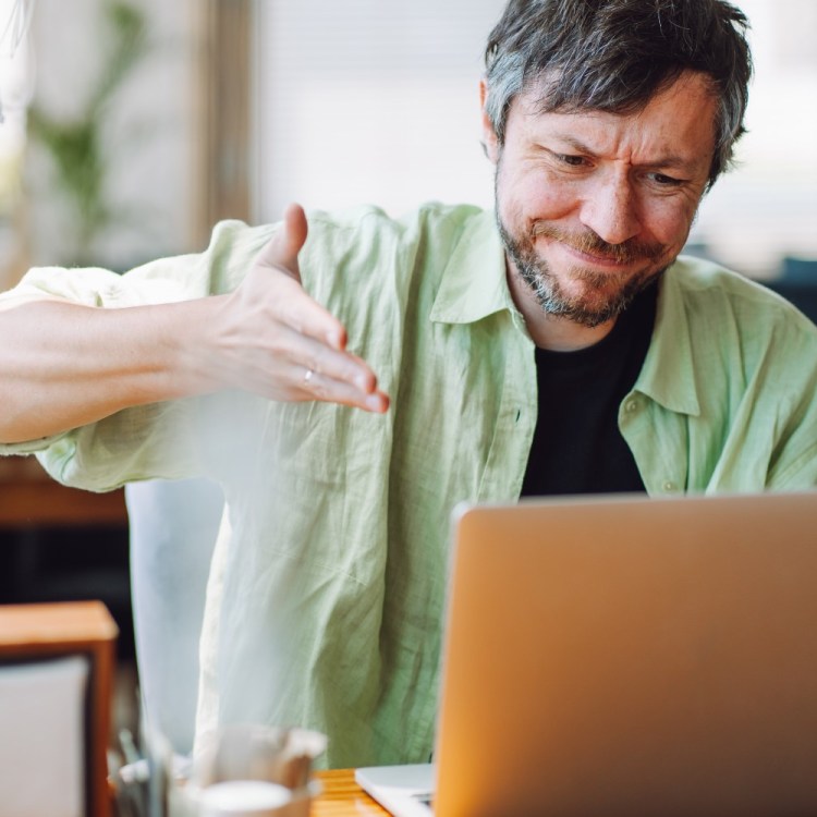 Angry man looking at laptop