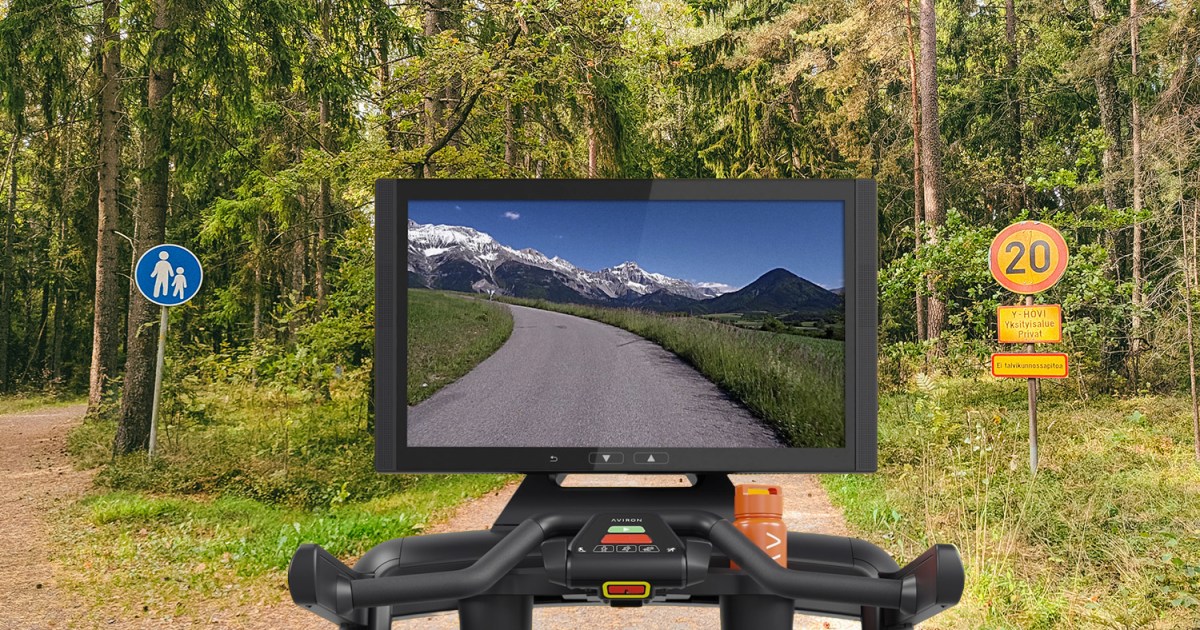A treadmill screen from the Aviron Victory Treadmill Plus superimposed on a woodland trail.