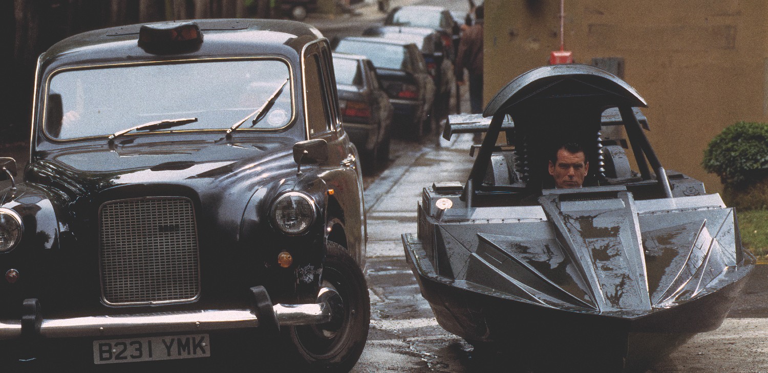 A car beside a boat on wheels