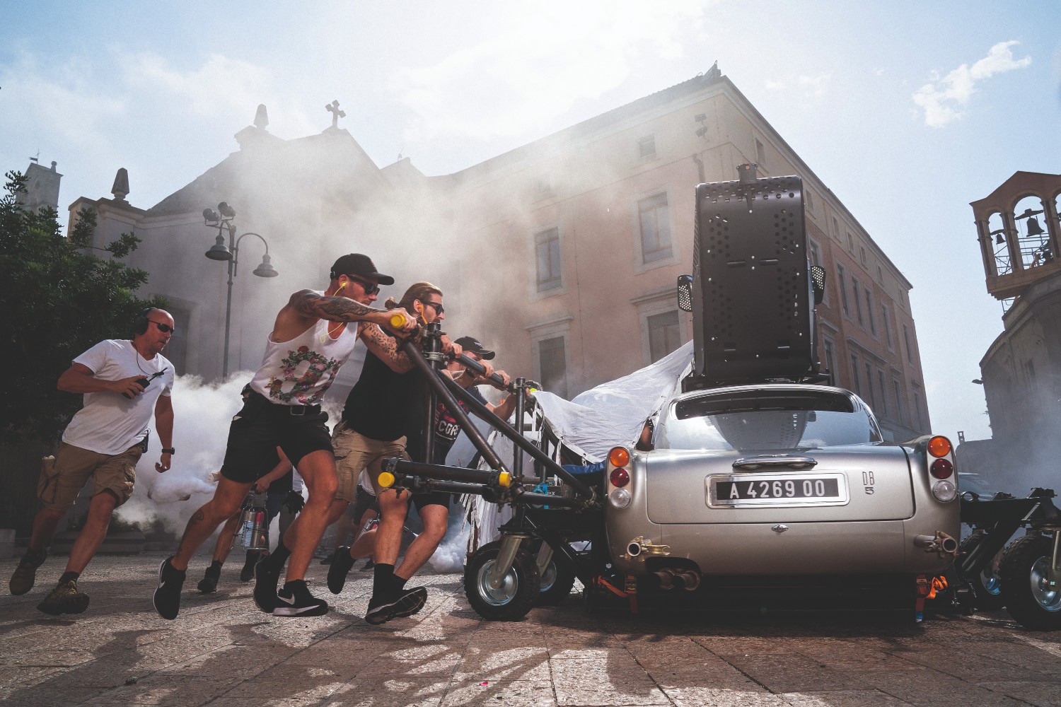 Crew members spinning a silver car