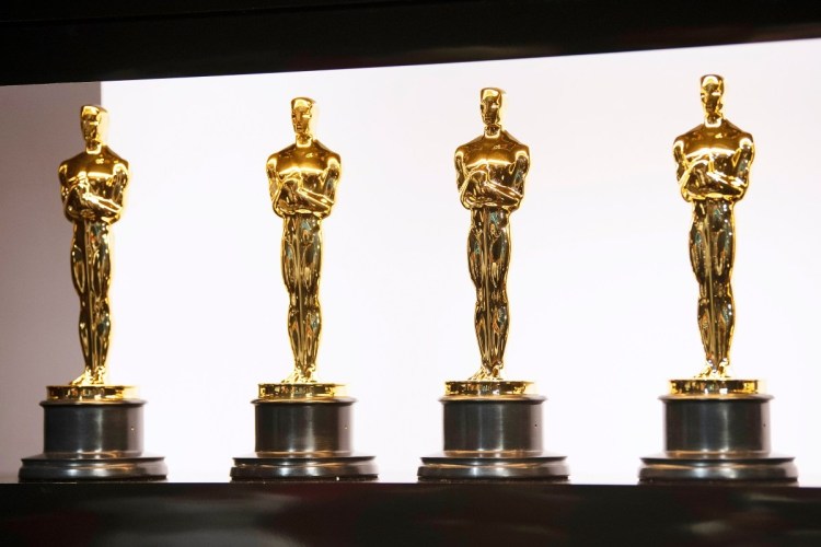 Academy Awards trophies in a line. We look at the biggest snubs and surprises from the 2026 Oscar nominations.