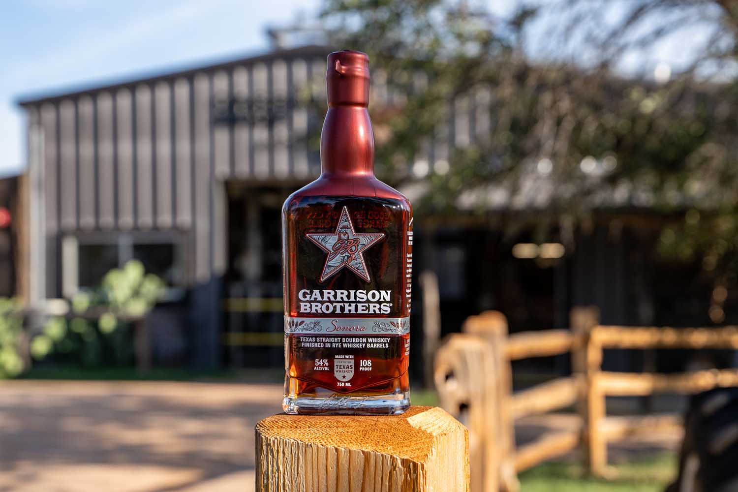 Garrison Brothers Sonora on a fence outside the distillery