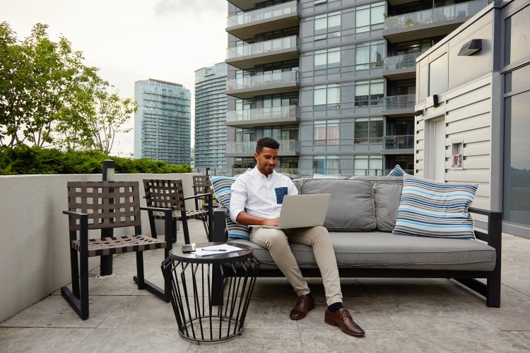 Man in Airbnb on laptop