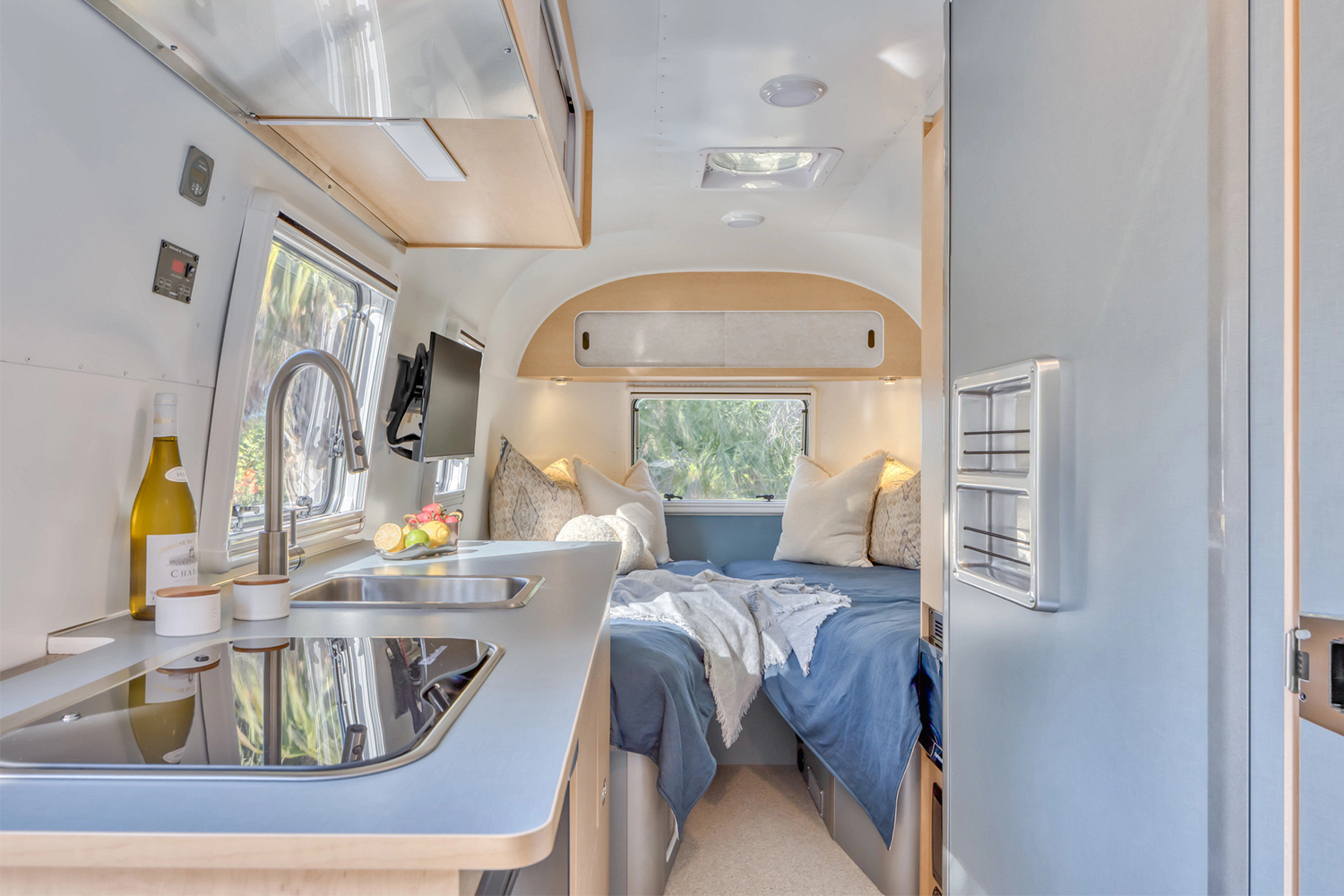 The interior of the Airstream World Traveler trailer, with a view of the two twin beds laid out in a V shape