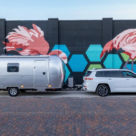 A white SUV towing the Airstream World Traveler, a new travel trailer that's spacious, affordable and easy to tow
