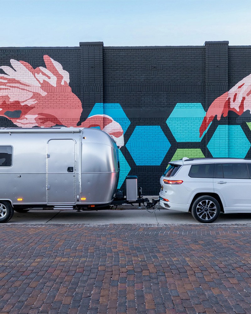 A white SUV towing the Airstream World Traveler, a new travel trailer that's spacious, affordable and easy to tow