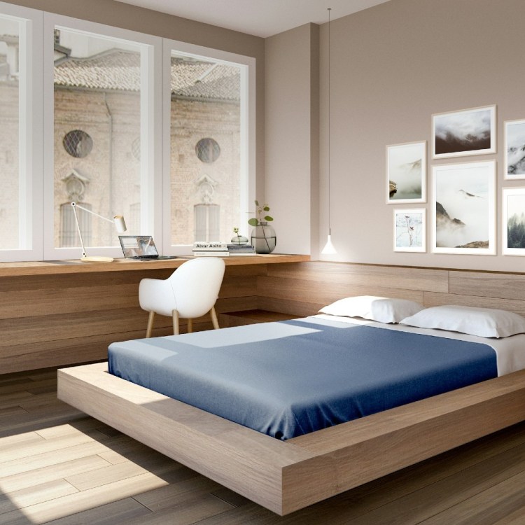 Bed near large windows